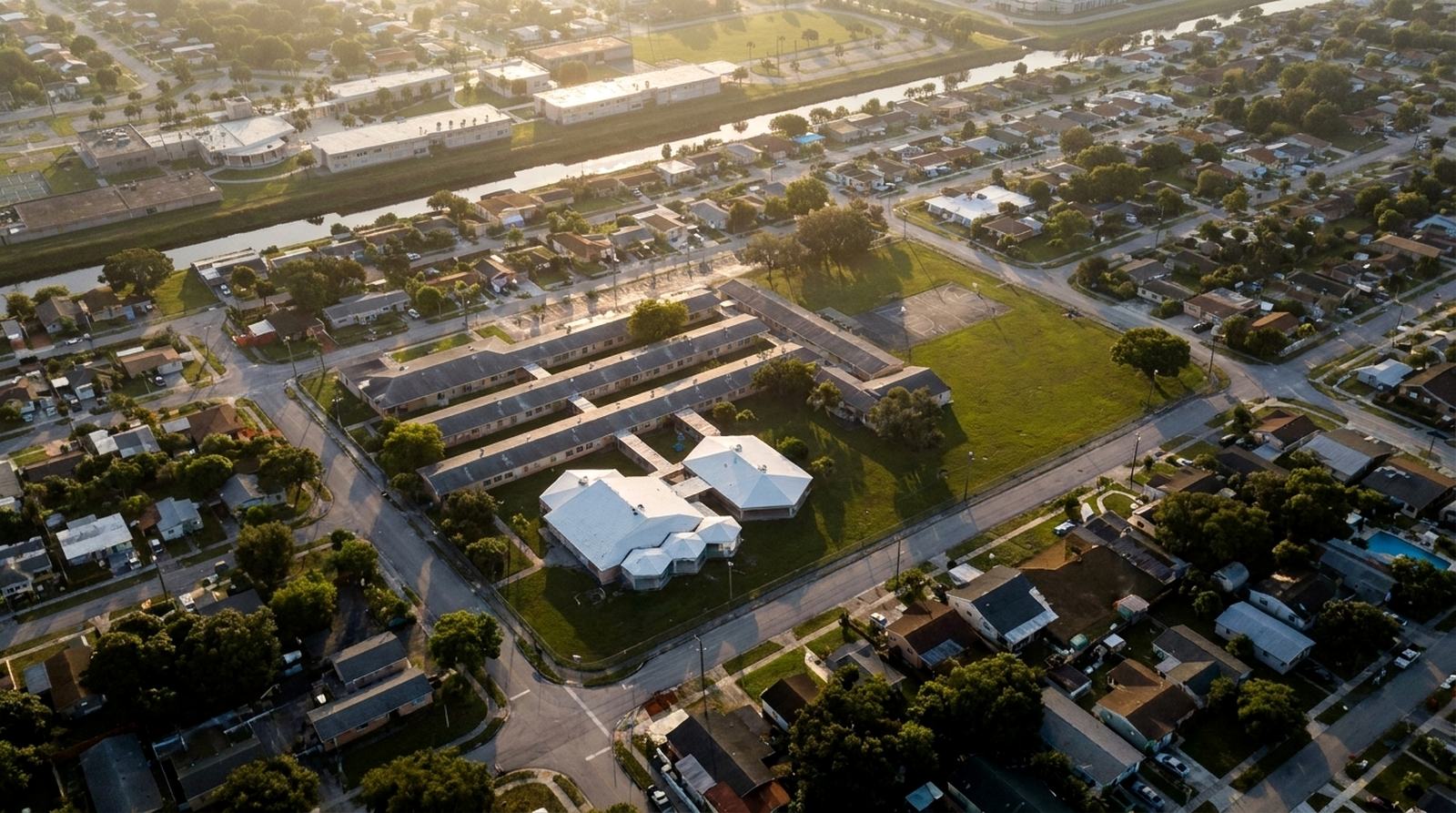 Cinematic dawn aerial rendering of Rainbow Park Elementary